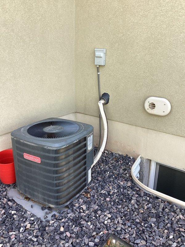 Completed annual air conditioner tune-up and preventative maintenance inspection on residential HVAC system. Performed comprehensive evaluation of Goodman furnace located in basement utility area, verifying proper operation of forced-air heating system, inspecting PVC venting connections, and checking condensate drainage lines for proper function. Inspected outdoor condenser unit, cleaned condenser coils, verified refrigerant levels, tested compressor operation, and ensured adequate airflow through fan assembly. Checked electrical connections at disconnect box and confirmed proper voltage supply to system. All components operating within manufacturer specifications with no deficiencies noted at time of service.