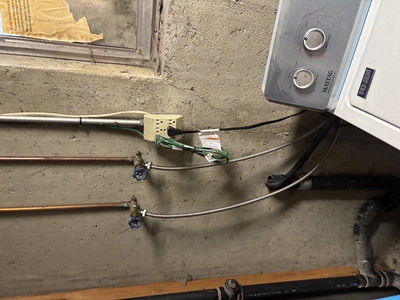 Responded to active sewage backup affecting entire home, with water flooding basement hallway, bathroom, and laundry room. Diagnosed main line blockage causing wastewater to back up through floor drains when washing machine and other plumbing fixtures were in use. Performed camera inspection of main sewer line to identify obstruction location and cause, then completed mainline cable snaking through accessible cleanout to clear blockage and restore proper drainage throughout residence.