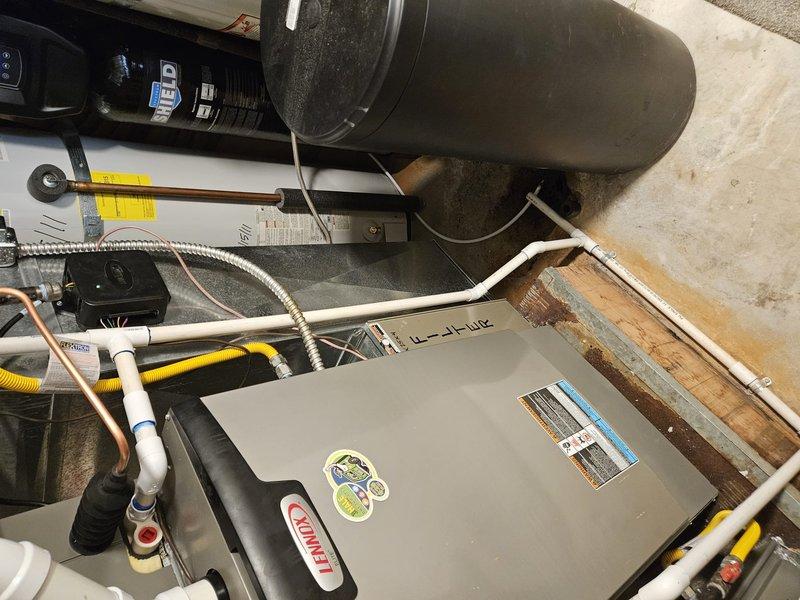 Completed installation of Lennox EL18KCV-048 air conditioning system with CK40CT-48C-71 evaporator coil and RDS communicating board 27A03. Flushed and reused existing lineset, installed unit on new EL3636-3 pad, and upgraded to Ecobee thermostat with remote room sensor for master bedroom placement. Installed 20x25x5 MERV 11 filter, verified all electrical connections including 40-amp fuses, routed thermostat wiring through walkout basement, and confirmed system operation with proper refrigerant charge and communication between components.