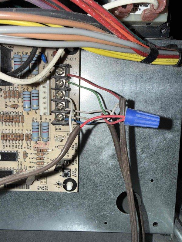 Responded to service call for non-operational HVAC system. Inspected TG9S060B12MP11A Category IV direct vent forced air furnace rated at 60,000 BTU input and 57,000 BTU output. Documented unit specifications including serial number W1E1049974 and verified manufacturer label information. Examined control board assembly and electrical connections, noting multiple wire terminations at circuit board terminal blocks including power supply, thermostat control wiring, and safety circuit connections. Photographed PCB components and wiring configuration for diagnostic purposes. System evaluation completed with visual inspection of all accessible electrical components and connections to determine cause of malfunction.