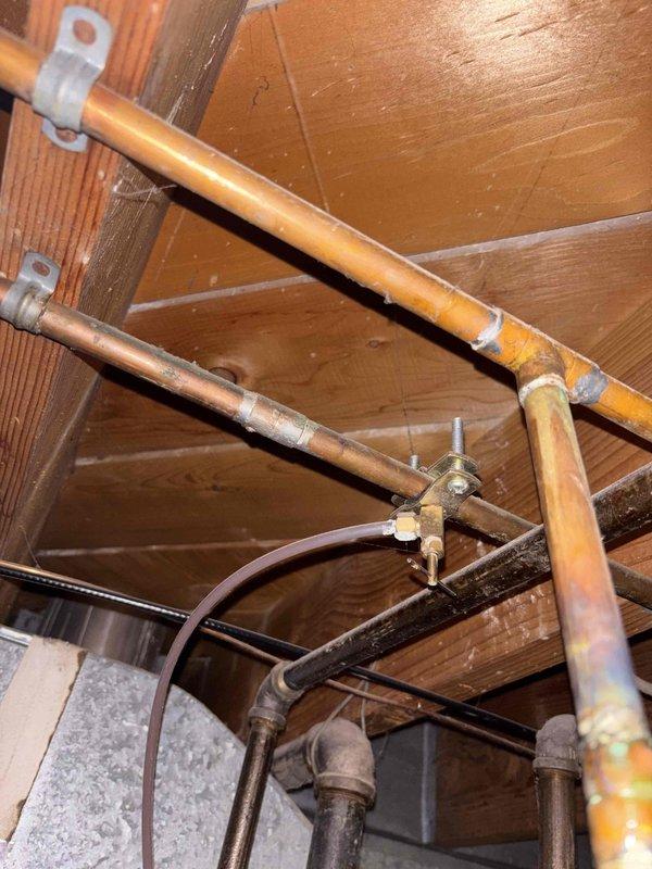 Responded to reported leak from humidifier saddle valve connection. Upon inspection, found the saddle tap valve on the water supply line feeding the furnace humidifier was stripped and actively leaking. Removed the defective saddle valve assembly from the water line. Properly capped and sealed the penetration point in the copper water line to eliminate the leak source. Verified repair integrity and confirmed no active leaks present upon completion.