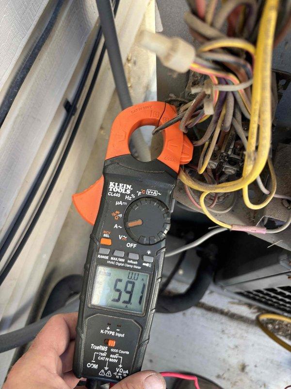 Responded to cooling complaint with inadequate upstairs temperature. Upon initial inspection, found evaporator coil frozen and allowed system to thaw, requiring return visit the following day. Completed Cool 10+ preventive maintenance service on single-zone residential air conditioning system. Performed comprehensive system inspection including capacitor testing, which measured 591 microfarads within acceptable range. Evaluated airflow distribution concerns between upper and lower levels of residence. Inspected outdoor condensing unit at ground level and indoor furnace/air handler located downstairs. System operational following thaw period with all electrical components functioning properly.