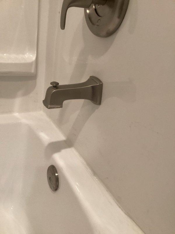 Returned to address tub spout issue from previous installation work. Repaired and secured brushed nickel tub spout fixture to ensure proper function and mounting stability. Verified shower diverter operation and confirmed all bathroom fixtures were working correctly upon completion.