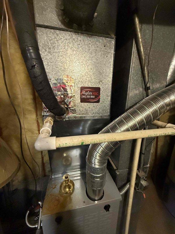 Responded to no-cooling complaint on 25-year-old residential air conditioning system with furnace located in basement. Performed diagnostic inspection on right-side condenser unit and associated air handler to determine cause of system failure. Upon evaluation, identified multiple component failures requiring system replacement, documented equipment condition with photographic evidence of exterior condenser location and basement furnace installation, and provided comprehensive replacement estimate for failed HVAC system.