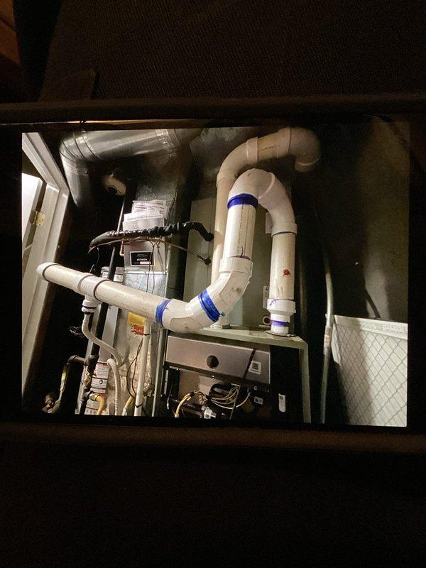 Responded to service call for cooling system failure with thermostat error code and 8-degree temperature differential between setpoint and actual room temperature. Inspected 3-year-old single-zone HVAC system with furnace and air conditioning unit located in basement. Accessed equipment through utility closet, examined air handler unit, condensate drainage system with PVC piping configuration, ductwork connections, and electrical components. Diagnosed and resolved thermostat communication issue, verified proper airflow through filter housing, and confirmed condensate drain lines were clear and functioning correctly. System restored to normal operation with temperature control responding appropriately to thermostat commands.