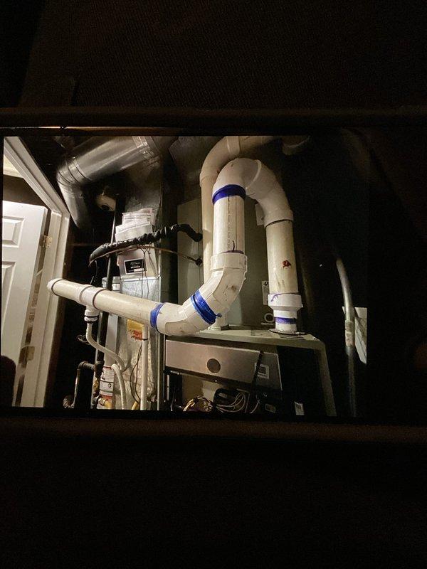 Responded to service call for cooling system failure with thermostat error code and 8-degree temperature differential between setpoint and actual room temperature. Inspected 3-year-old single-zone HVAC system with furnace and air conditioning unit located in basement. Accessed equipment through utility closet, examined air handler unit, condensate drainage system with PVC piping configuration, ductwork connections, and electrical components. Diagnosed and resolved thermostat communication issue, verified proper airflow through filter housing, and confirmed condensate drain lines were clear and functioning correctly. System restored to normal operation with temperature control responding appropriately to thermostat commands.