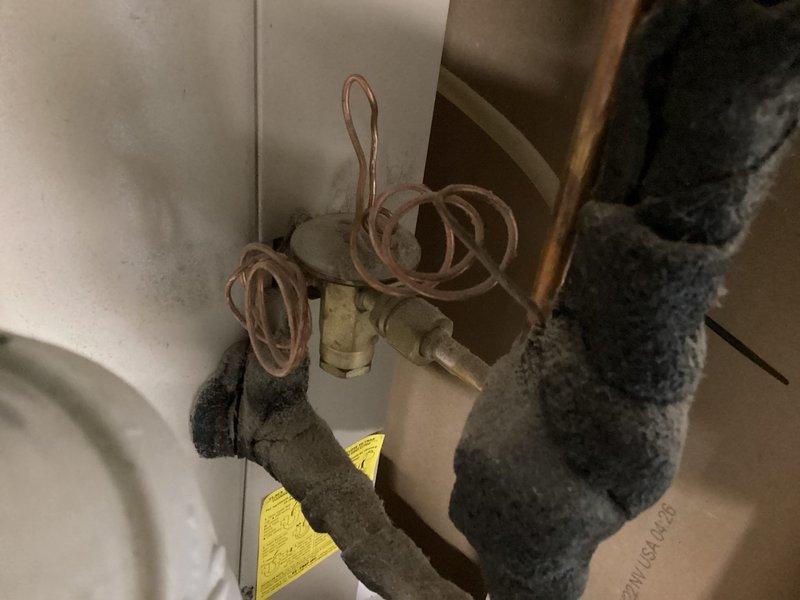 Responded to report of water leakage from AC unit in basement cold storage area. Upon arrival, performed comprehensive Cool 10+ preventive maintenance inspection on 15+ year old system. Inspected refrigerant lines, copper coil connections, and insulated piping for signs of condensate issues. Examined furnace blower assembly, gas valve components, and electrical connections. Verified proper drainage pathways and checked for blocked condensate lines that could cause water overflow. Completed system evaluation and documented equipment condition with photos showing refrigerant line configuration and internal furnace components.
