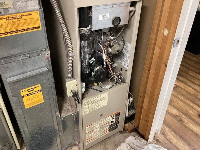 Responded to report of water leakage from AC unit in basement cold storage area. Upon arrival, performed comprehensive Cool 10+ preventive maintenance inspection on 15+ year old system. Inspected refrigerant lines, copper coil connections, and insulated piping for signs of condensate issues. Examined furnace blower assembly, gas valve components, and electrical connections. Verified proper drainage pathways and checked for blocked condensate lines that could cause water overflow. Completed system evaluation and documented equipment condition with photos showing refrigerant line configuration and internal furnace components.