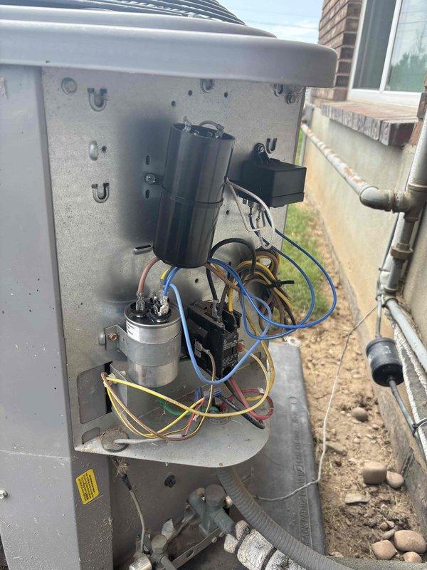 Responded to no cooling complaint on 10+ year old residential split system with history of refrigerant leaks. Performed diagnostic evaluation of outdoor condensing unit and indoor air handler. Inspected electrical components including capacitor, contactors, and control wiring in outdoor unit compartment. Evaluated basement-mounted furnace/air handler assembly including ductwork connections, condensate drainage system, and refrigerant line set for proper operation and potential leak points.