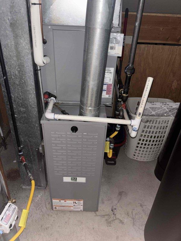 Responded to no cooling complaint on 10+ year old residential split system with history of refrigerant leaks. Performed diagnostic evaluation of outdoor condensing unit and indoor air handler. Inspected electrical components including capacitor, contactors, and control wiring in outdoor unit compartment. Evaluated basement-mounted furnace/air handler assembly including ductwork connections, condensate drainage system, and refrigerant line set for proper operation and potential leak points.