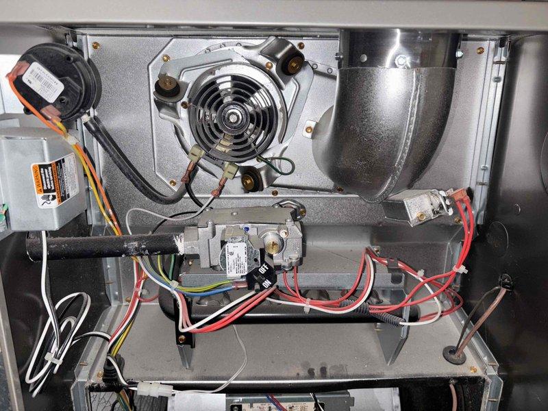 Responded to service call for 8-year-old residential air conditioning system that developed loud unusual noises following power outage and restoration. Upon arrival, performed diagnostic inspection of single-zone AC system with condenser located on west side of property and furnace in basement laundry room. Conducted thorough examination of condenser unit exterior components and inspected draft inducer motor assembly, blower components, and electrical wiring connections inside furnace cabinet to identify source of noise complaint and ensure system integrity after power interruption.