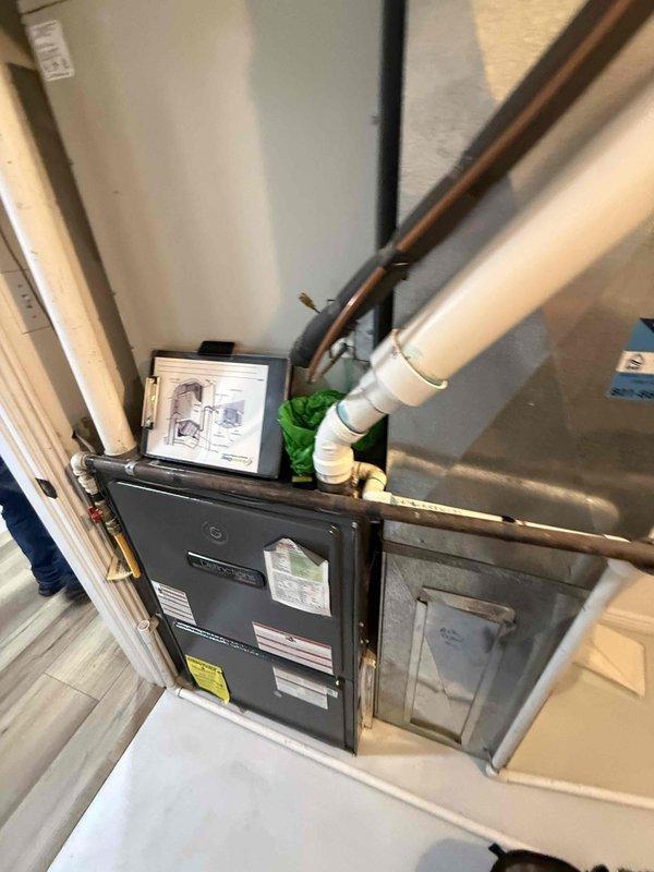 Responded to no-cooling call on 20+ year old residential air conditioning system. Diagnosed compressor drawing excessive amperage, causing repeated fuse failures and complete system shutdown. Documented furnace and AC unit configuration with basement furnace location and exterior condenser placement, inspected control board wiring and electrical connections, and provided system replacement options due to age and extent of electrical failure.