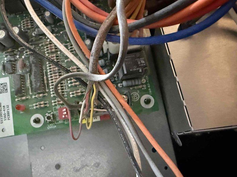 Responded to no-cooling call on 20+ year old residential air conditioning system. Diagnosed compressor drawing excessive amperage, causing repeated fuse failures and complete system shutdown. Documented furnace and AC unit configuration with basement furnace location and exterior condenser placement, inspected control board wiring and electrical connections, and provided system replacement options due to age and extent of electrical failure.