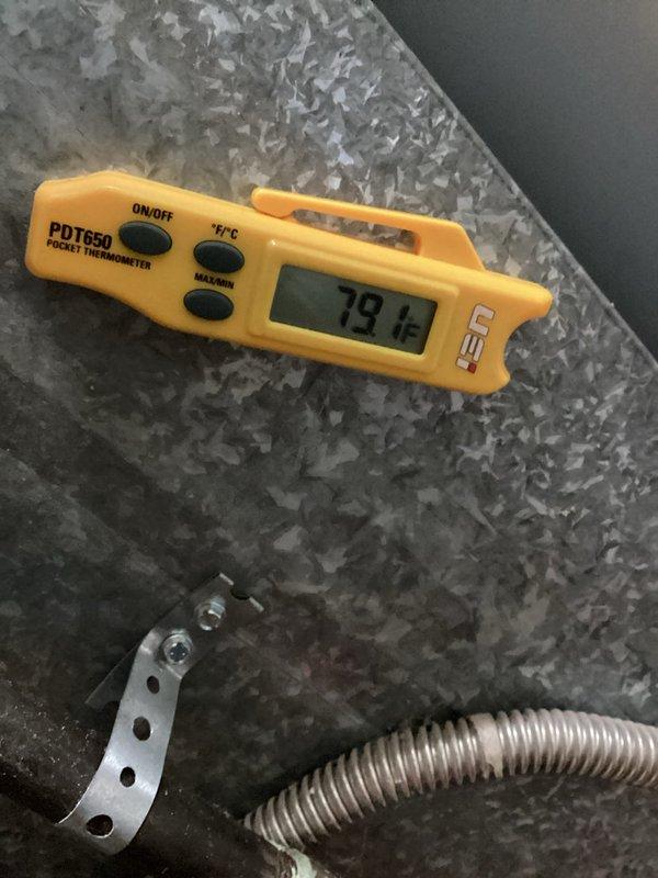 Responded to service call for single-zone residential HVAC system with frozen evaporator coil causing inadequate cooling. Upon arrival, confirmed coil had thawed sufficiently to proceed with diagnostic evaluation. Inspected furnace located in basement and outdoor condensing unit at rear of property. Examined refrigerant lines, insulation integrity, and control components within air handler cabinet. Measured supply air temperature at 79.1°F, confirming insufficient cooling capacity. Evaluated potential causes of coil freezing including restricted airflow, low refrigerant charge, and system operation parameters. Documented system conditions with thermal readings and visual inspection of refrigerant line connections, insulation wrapping, and control wiring. Coordinated service timing with homeowner via text communication to ensure evaporator coil had adequate time to defrost before technician arrival, preventing damage to compressor and allowing proper system assessment.