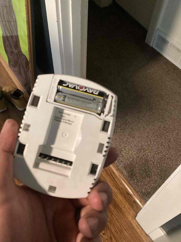 Responded to no-cooling call on 9-year-old residential air conditioning system. Upon arrival, found thermostat display completely blank with no power. Inspected thermostat and discovered depleted batteries in the Honeywell programmable unit. Replaced batteries with fresh Rayovac cells, restoring power to thermostat display. Verified thermostat functionality and confirmed proper communication with HVAC system. Unit returned to normal operation with cooling cycle initiated successfully.