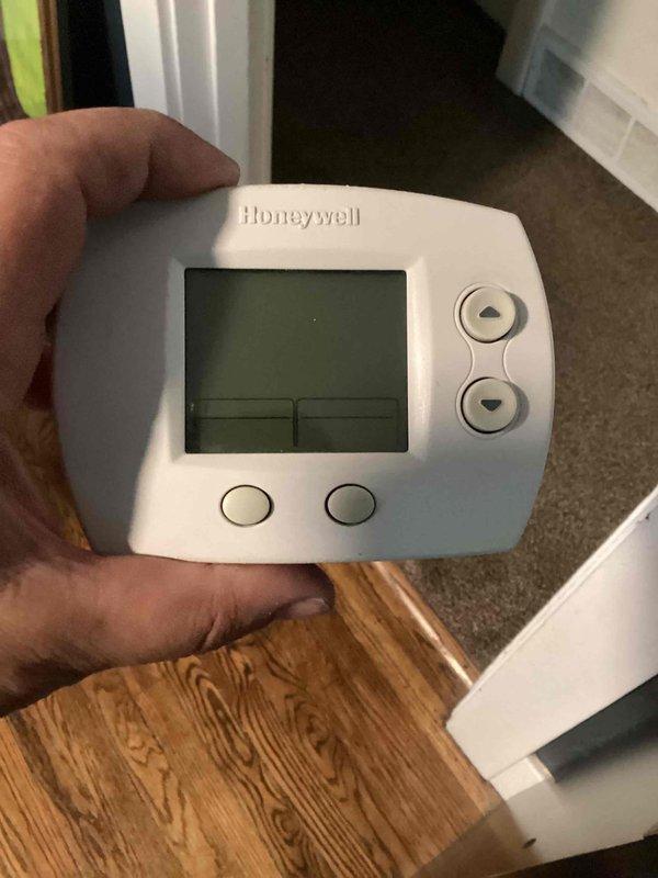 Responded to no-cooling call on 9-year-old residential air conditioning system. Upon arrival, found thermostat display completely blank with no power. Inspected thermostat and discovered depleted batteries in the Honeywell programmable unit. Replaced batteries with fresh Rayovac cells, restoring power to thermostat display. Verified thermostat functionality and confirmed proper communication with HVAC system. Unit returned to normal operation with cooling cycle initiated successfully.
