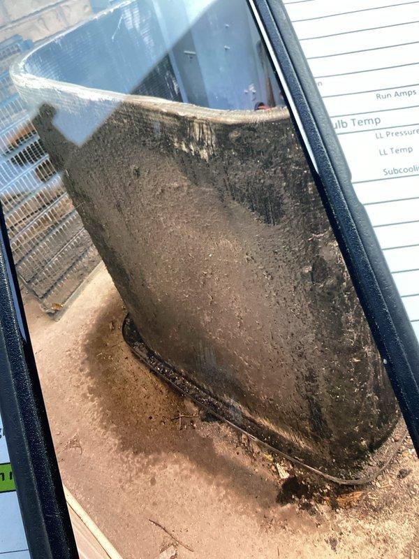 Responded to no-cooling call on 18+ year old single-zone residential air conditioning system with condenser located on back porch and furnace on main level. Upon inspection, found severely clogged condenser coil with heavy dirt and debris accumulation restricting airflow, and extremely dirty air filter with significant particulate buildup causing reduced system airflow. Performed Cool 10+ preventive maintenance including condenser coil cleaning, replaced air filter, checked refrigerant pressures and temperatures, verified amperage draw on compressor and condenser fan motor, and confirmed proper system operation with adequate subcooling levels upon completion.