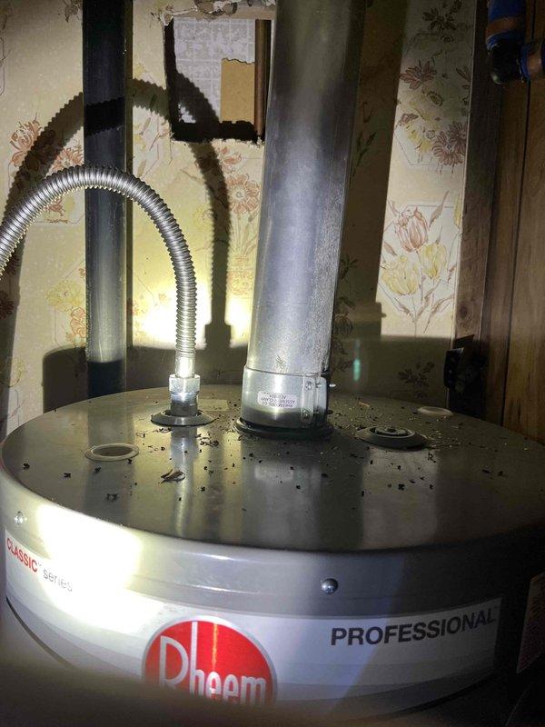 Responded to residential plumbing call for pilot light failure on one-year-old Rheem Professional Classic tank-style water heater resulting in no hot water for two days. Upon arrival, inspected unit located in utility area and diagnosed pilot light ignition issue. Successfully relit pilot assembly, verified proper flame characteristics, and tested thermocouple operation to ensure safe and reliable ignition system function. Confirmed water heater returned to normal operation with adequate hot water production restored.