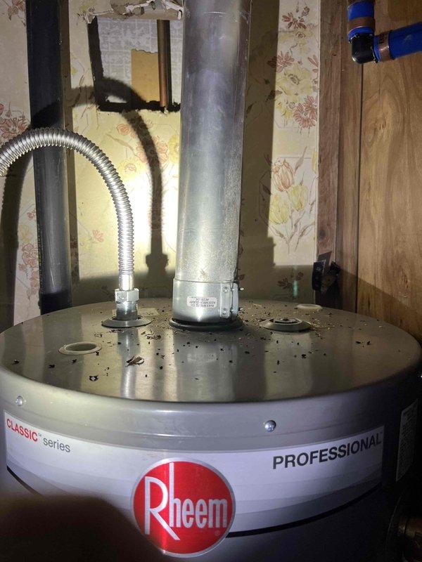 Responded to residential plumbing call for pilot light failure on one-year-old Rheem Professional Classic tank-style water heater resulting in no hot water for two days. Upon arrival, inspected unit located in utility area and diagnosed pilot light ignition issue. Successfully relit pilot assembly, verified proper flame characteristics, and tested thermocouple operation to ensure safe and reliable ignition system function. Confirmed water heater returned to normal operation with adequate hot water production restored.