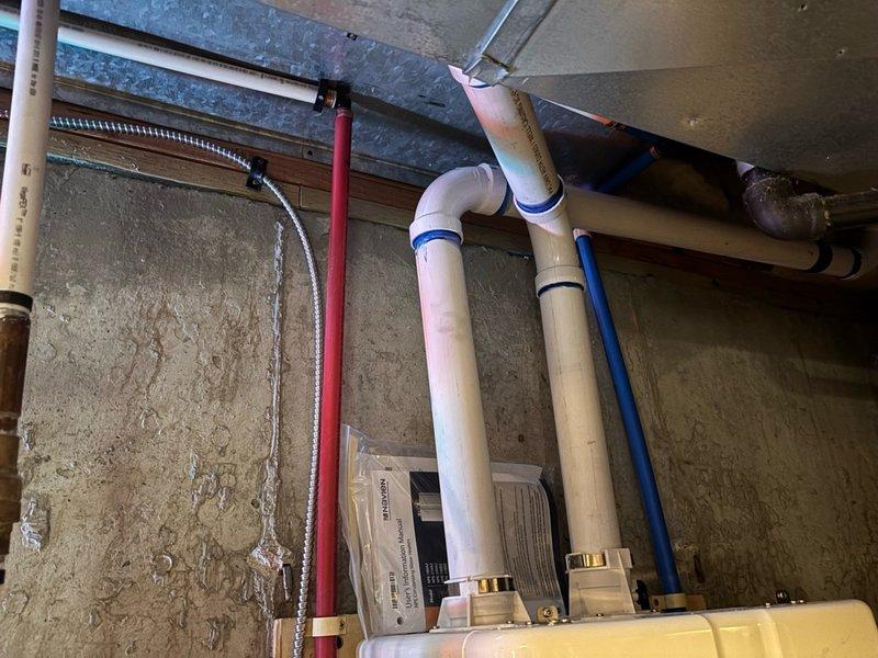 Successfully installed Navien tankless 240A water heater with all code-compliant requirements, including 2" exhaust and fresh air venting through exterior wall, 3/4" gas supply line, and 3/4" PEX water lines with isolation valves for future maintenance access. Removed existing water heating units, tested new system for proper operation, and verified all connections meet manufacturer specifications with 5-year parts warranty and 15-year heat exchanger warranty coverage.