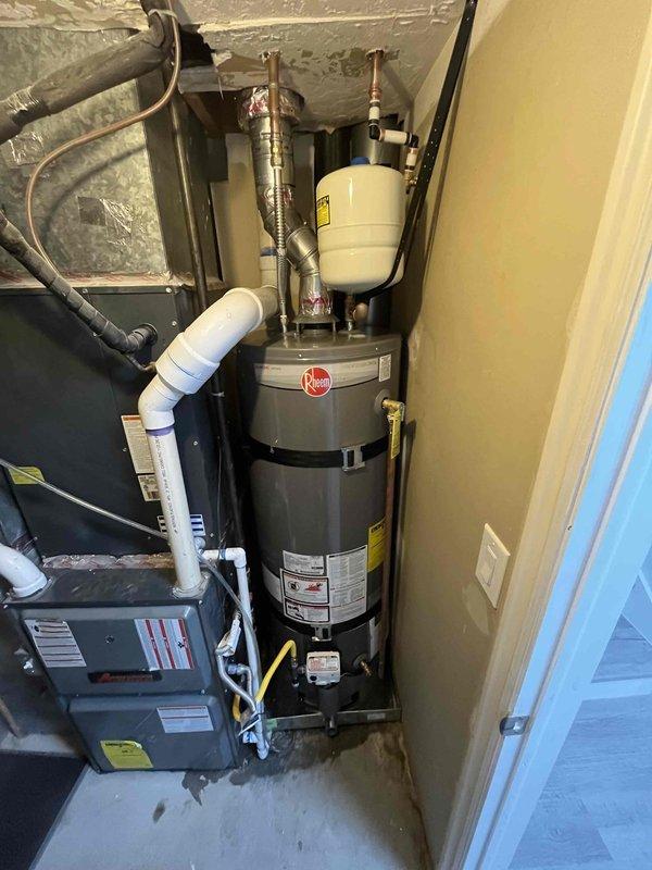 Completed full installation of 50-gallon Rheem water heater in residential utility closet with all code-compliant components including proper venting, thermal expansion tank, earthquake straps, new copper supply lines, and shutoff valve. Removed and disposed of existing unit, installed new water heater with 3/4" PRV and hose bib, tested all connections for leaks, verified proper gas flow and combustion, and confirmed unit operation meets manufacturer specifications.