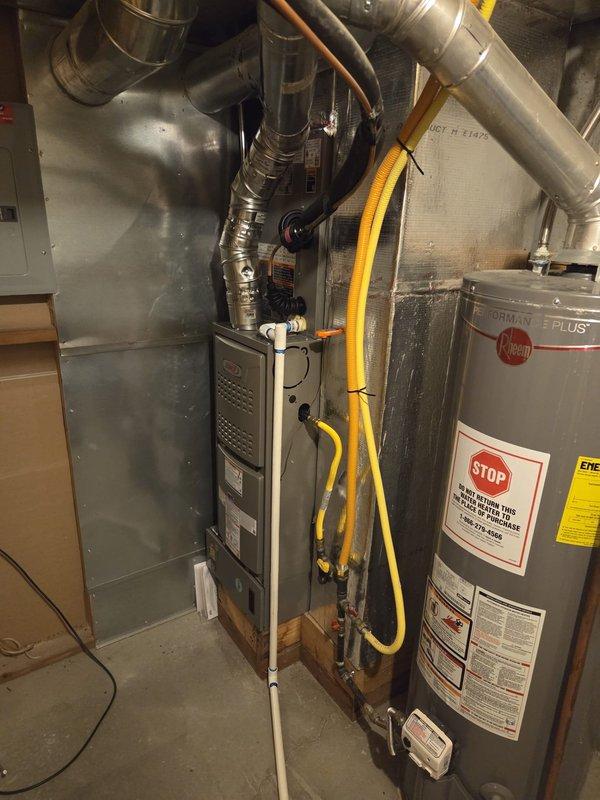 Completed full HVAC system replacement including installation of Lennox ML180UH070E36AK 80% efficiency furnace, ML14KC1-030 air conditioning unit with CK40CT-30A-71 evaporator coil, and T6 Pro thermostat with white backplate. Installed new AC pad (EL3030-3) for outdoor condenser unit and flushed existing lineset for reuse. Fabricated and installed custom sheet metal ductwork transitions, double wall venting system, and rocket box for proper exhaust venting. Installed new 16x25x1 filter rack with four replacement filters for improved air quality. Performed complete system startup, verified refrigerant pressures and system performance using manifold gauges, confirming proper operation of both heating and cooling systems. Protected work areas with drop cloths throughout installation process in basement mechanical room.