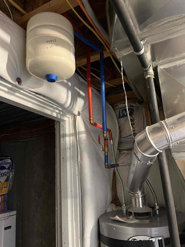 Completed comprehensive plumbing and water heater maintenance inspection as part of Green Shield Protection Plan membership service. Performed thorough visual inspection of residential water heater system, expansion tank, and associated plumbing infrastructure located in mechanical room. Examined white cylindrical expansion tank mounting, connections, and pressure vessel integrity. Inspected copper supply lines including hot and cold water piping, verifying proper color coding and secure connections to water heater unit. Evaluated flexible metal connectors and verified proper installation between water heater and distribution system. Assessed PVC piping runs and connections for proper support and alignment. Documented all mechanical equipment conditions including water heater exterior, expansion tank positioning, and ductwork proximity to plumbing components. Verified proper clearances around equipment and confirmed adequate ventilation in utility space. All systems found to be functio