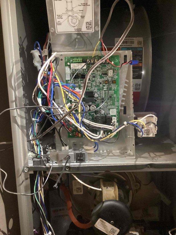 Responded to callback for AC unit running sporadically on system less than one year old. Accessed control panel in hallway closet and inspected PCB wiring connections, terminal points, and electronic components. Verified proper wire connections at control board terminals using diagnostic procedures, documented internal panel configuration and wiring harness routing for service records.