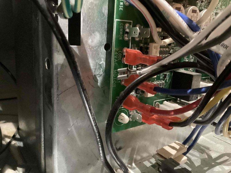 Responded to callback for AC unit running sporadically on system less than one year old. Accessed control panel in hallway closet and inspected PCB wiring connections, terminal points, and electronic components. Verified proper wire connections at control board terminals using diagnostic procedures, documented internal panel configuration and wiring harness routing for service records.