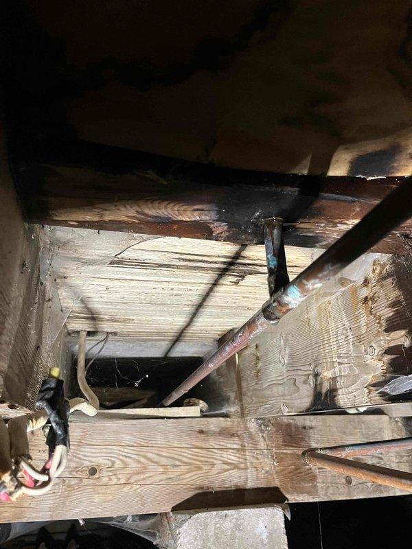 Responded to a burst pipe emergency in the crawlspace where a corroded pipe was actively leaking and spraying water upward. Accessed the crawlspace, located the failed section of corroded piping among the floor joists and existing utility lines, and replaced the damaged pipe section to restore water service and prevent structural damage to the home.