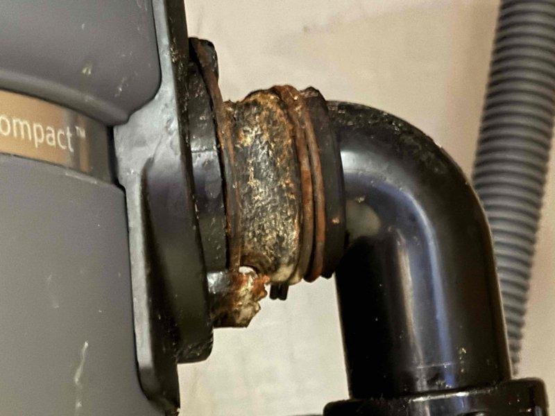 Responded to service call for non-functional garbage disposal unit. Upon inspection, found 20-year-old disposal with severely corroded mounting assembly and deteriorated drain connections showing extensive rust and oxidation. Assessed existing sink drain fixture and disposal mounting hardware, noting significant mineral deposits and age-related deterioration throughout the system. Provided quote for complete disposal replacement including new mounting assembly and drain connections to restore proper functionality.