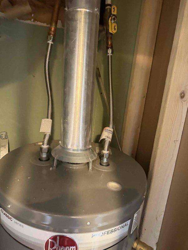 Completed membership plumbing inspection on 5-year-old Rheem tanked water heater located in basement. Inspected unit condition, verified proper operation of water heater components, and examined all plumbing connections including flexible stainless steel braided supply lines and galvanized flue venting system. Checked copper fittings, valves, and associated mechanical equipment. All systems found operating within normal parameters with no immediate service needs identified.