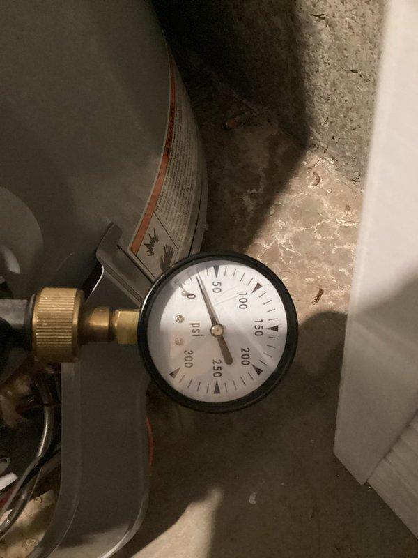 Responded to water pressure complaint at 1954-era residence where homeowner reported near-zero water pressure following recent water heater replacement by another contractor. Inspected plumbing system and pressure tank in utility area, noting pressure gauge readings on existing equipment. Evaluated bathroom fixtures and tested water flow at vanity sink to verify reported low-pressure condition throughout the dwelling. Documented pressure tank configuration and gauge readings to diagnose system performance issues potentially related to previous water heater installation work.