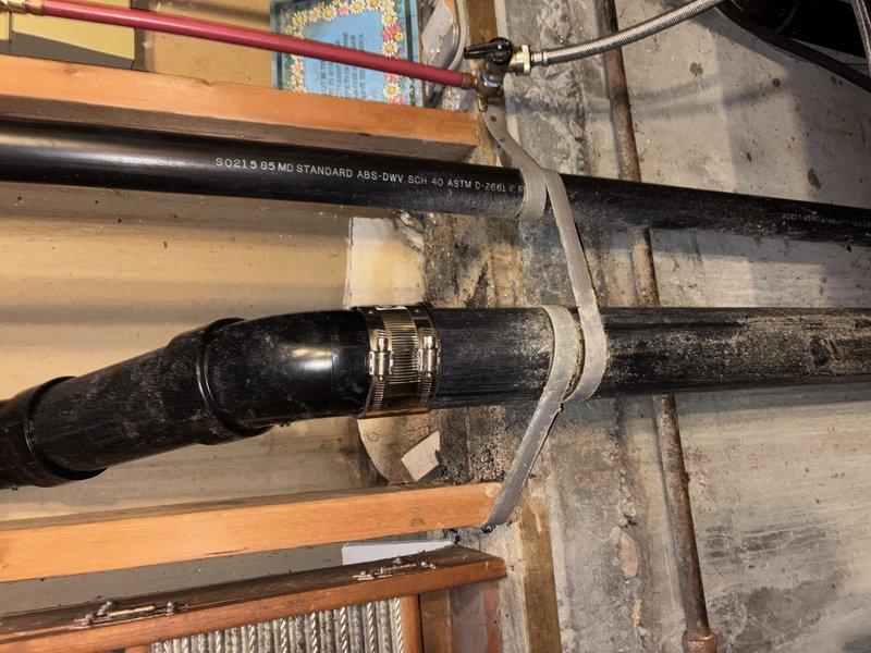 Replaced and installed Schedule 40 PVC plumbing pipes in basement crawl space area. Secured new pipe runs to floor joists using metal hose clamps and strapping brackets, ensuring proper support and alignment throughout the installation. Verified all connections were properly fastened and system was operational upon completion.