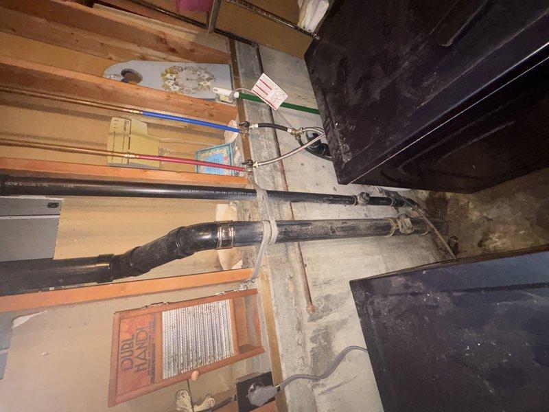 Replaced and installed Schedule 40 PVC plumbing pipes in basement crawl space area. Secured new pipe runs to floor joists using metal hose clamps and strapping brackets, ensuring proper support and alignment throughout the installation. Verified all connections were properly fastened and system was operational upon completion.