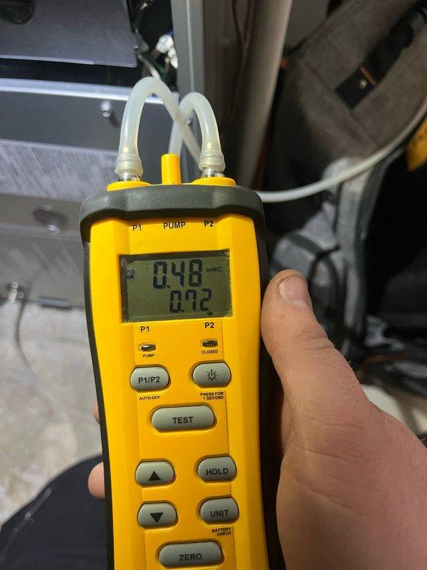 Responded to service call for non-functional external AC unit on 12-year-old residential system. Performed comprehensive Cool 10+ preventive maintenance inspection on furnace system located in basement. Removed access panel and conducted thorough visual inspection of internal components including blower motor assembly, gas valve, and electrical connections. Tested and verified proper operation of control board and capacitors. Utilized digital manometer to measure static pressure readings, recording 0.48 and 0.12 InWC across system pressure points to ensure proper airflow and system performance. Inspected all wire harnesses and electrical connections for secure mounting and proper routing. System returned to normal operation following diagnostic evaluation and maintenance procedures.