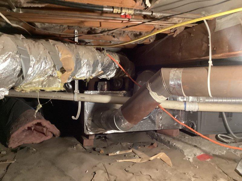 Responded to no-cooling complaint and performed comprehensive system evaluation. Identified multiple design and operational issues with existing split system including furnace in crawlspace and outdoor condensing unit. Assessed crawlspace HVAC installation including ductwork configuration, flexible and rigid duct connections, and overall system layout. Presented equipment replacement options including ductless mini-split system with multiple head configurations and complete conventional split system replacement to address systemic failures and improve performance.