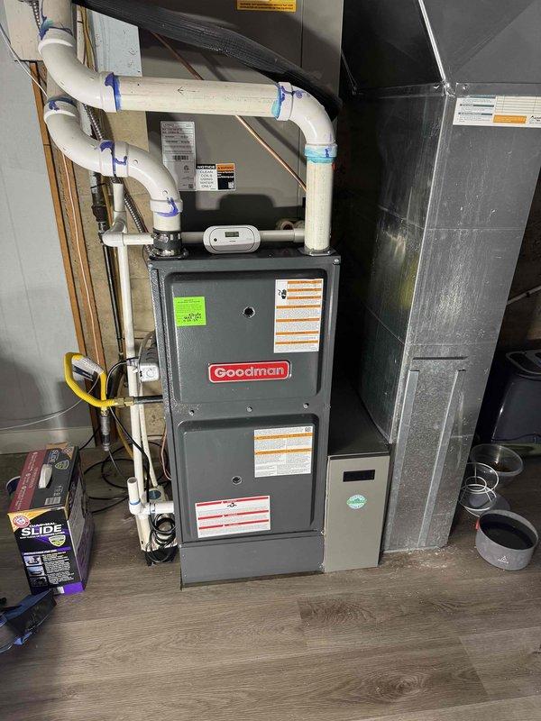 Responded to no-cooling call on residential split system less than one year old. Performed diagnostic inspection on basement-installed furnace and outdoor condensing unit. Found outdoor unit condenser coil heavily soiled with dirt and debris accumulation causing restricted airflow and reduced heat transfer efficiency. Cleaned condenser coil, verified proper refrigerant pressures, and tested system operation. Unit restored to normal cooling function with improved airflow across coil surfaces.
