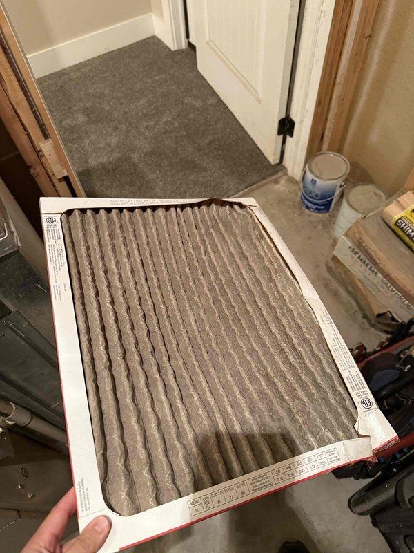 Responded to service call for two-zone HVAC system with upstairs zone experiencing operational issues following coil freeze-up approximately two weeks prior. Upon inspection, discovered severely restricted airflow due to heavily soiled air filters on 7+ year old system. Removed and documented condition of both filters showing excessive dust and debris accumulation, which caused inadequate airflow leading to evaporator coil icing and subsequent system malfunction. Replaced filters to restore proper airflow and system operation for affected upstairs zone.