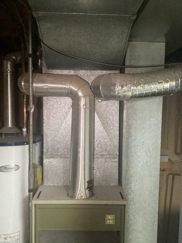 Completed estimate for residential HVAC system replacement at property currently equipped with rooftop swamp cooler. Assessed basement installation site for new forced-air furnace and central air conditioning system, including evaluation of existing ductwork infrastructure and electrical service requirements. Inspected furnace location near laundry area and electrical panel in downstairs bedroom to determine scope of work for complete system conversion from evaporative cooling to refrigerated air conditioning with compatible heating unit.