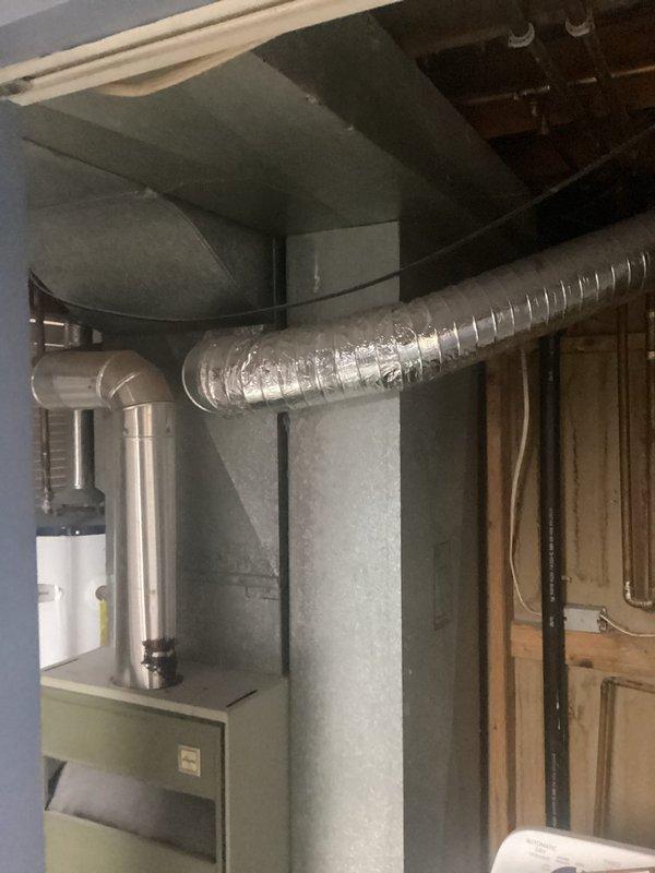 Completed estimate for residential HVAC system replacement at property currently equipped with rooftop swamp cooler. Assessed basement installation site for new forced-air furnace and central air conditioning system, including evaluation of existing ductwork infrastructure and electrical service requirements. Inspected furnace location near laundry area and electrical panel in downstairs bedroom to determine scope of work for complete system conversion from evaporative cooling to refrigerated air conditioning with compatible heating unit.