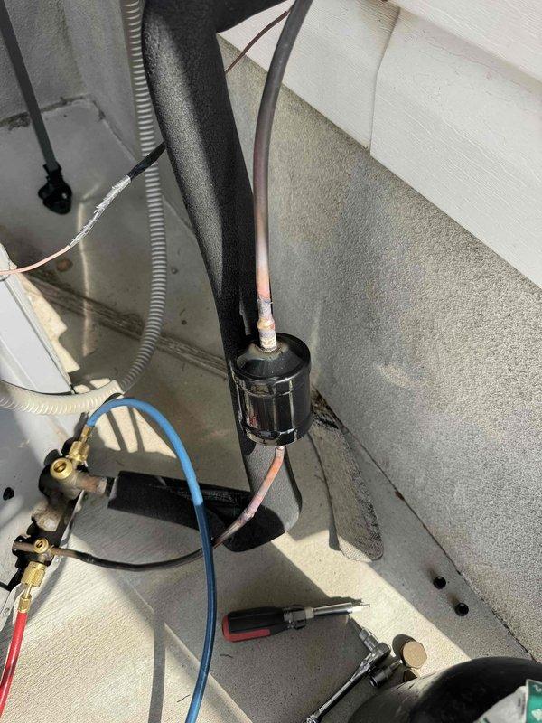 Responded to call for additional refrigerant needed on residential air conditioning system. Upon arrival, performed comprehensive system diagnostics and discovered unit was significantly overcharged with refrigerant, likely from previous service work performed without proper system analysis. Conducted pressure and temperature readings using manifold gauges and digital testing equipment to confirm overcharge condition.

Further investigation revealed TXV valve was clogged and system had been improperly serviced previously with no filter dryer installed during prior repairs. Determined there was no refrigerant leak present; system issues were solely due to overcharge condition and contaminated metering device from lack of proper filtration.

Recovered excess refrigerant from system using recovery equipment to bring charge to manufacturer specifications. Replaced clogged thermostatic expansion valve with new TXV to restore proper metering function. Installed new filter dryer in liquid lin