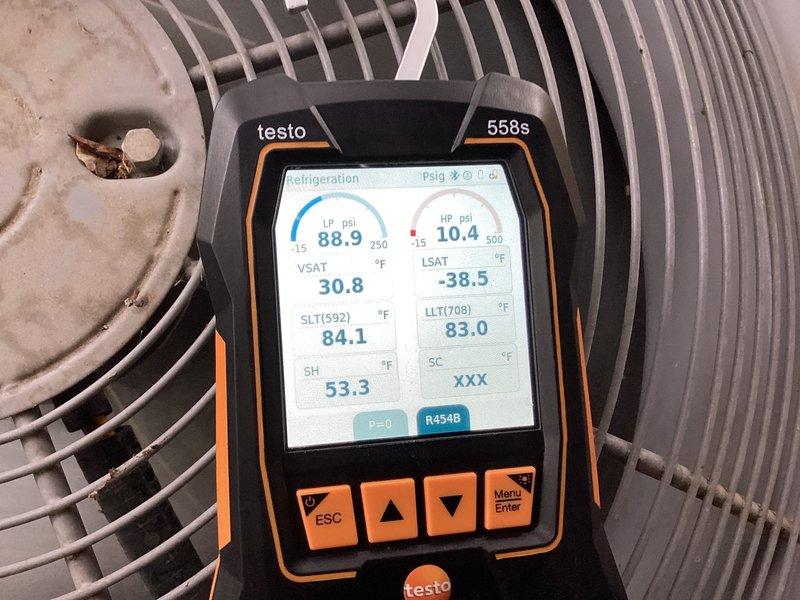 Responded to cooling system issue on 5-6 year old single-zone HVAC unit with previous evaporator coil freeze-up that had thawed. Performed comprehensive diagnostic evaluation using Testo 558s refrigerant analyzer, measuring system pressures, superheat, subcooling, and saturation temperatures on R454B refrigerant system. Recorded operating pressures at 10.4 psi suction side with supply air temperature at 51°F. System temperatures showed 88.9°F and 84.1°F on condenser side with subcooling and superheat readings indicating potential refrigerant charge or airflow concerns that led to initial freeze condition.