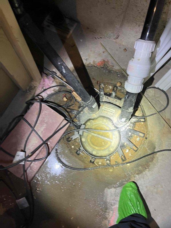 Responded to service call for toilet resealing and drain obstruction. Upon arrival, performed diagnostic evaluation of the affected fixture and drainage system. Successfully resealed toilet to eliminate leak at base connection point, ensuring proper wax ring installation and secure mounting to floor flange. Cleared drain obstruction using appropriate tools and techniques to restore full flow capacity. Inspected basement plumbing infrastructure including sump pump assembly, drainage lines, and associated piping systems to verify no additional issues were present. Noted water staining on concrete floor surrounding pump pit area, indicating previous moisture exposure. All plumbing fixtures tested and confirmed operational upon completion of repairs.