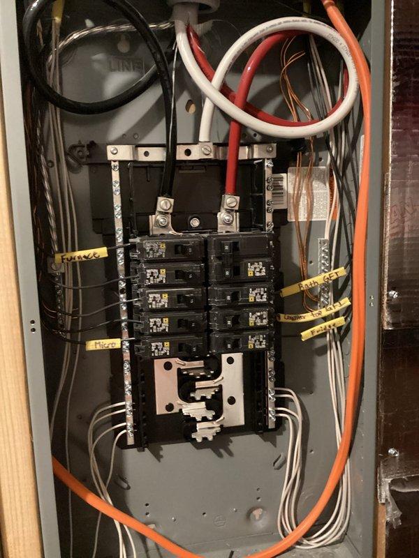 Completed comprehensive electrical safety inspection as part of recurring membership maintenance visit. Performed thorough examination of main electrical service panel, verifying proper operation of all circuit breakers, inspecting bus bar connections and main lugs for signs of overheating or corrosion, and confirming appropriate wire routing and bundling throughout the panel. Documented panel configuration with detailed photographs showing breaker arrangement, circuit labeling for entry, range, air conditioning units, disposal, and attic lighting circuits, and overall system condition. No deficiencies, safety hazards, or electrical issues identified during inspection. All components found to be functioning properly with adequate wire management and secure connections.