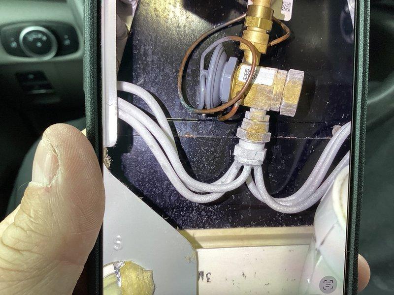 Responded to cooling complaint on second-floor unit in a two-system residential property. Upon arrival, performed comprehensive Cool 10+ maintenance service including system diagnostics with digital manifold gauges. Measured operating pressures showing low-side at 32.8 PSI and high-side at 253.7 PSI with various temperature readings ranging from 73.8°F to 84.6°F. Inspected condenser unit and refrigerant lines for reported ice formation and potential leaks, finding no active refrigerant leaks or abnormal ice accumulation at time of service. Examined indoor air handler plumbing connections and drainage components, verifying proper operation of condensate system and associated fittings. Documented system conditions with photos of internal components and diagnostic readings for service records.