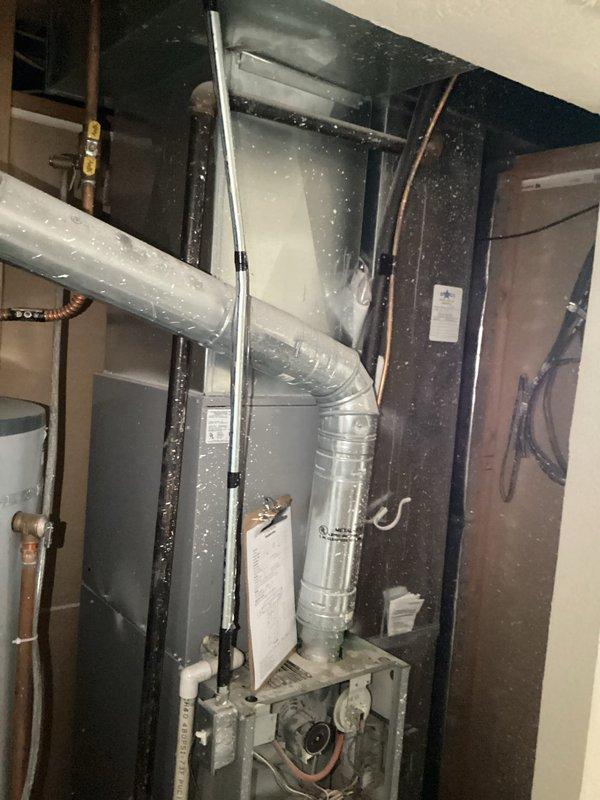 Responded to service call for 22-25 year old residential air conditioning system with non-operational condenser fan motor and failing compressor. Performed diagnostic evaluation of outdoor unit and confirmed fan motor failure despite recent capacitor replacement by homeowner. Assessed compressor condition and determined unit had reached end of serviceable life. Presented repair options and full system replacement recommendations for the single-zone HVAC system with basement furnace installation.
