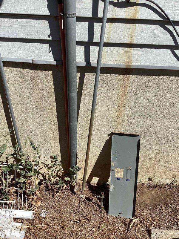 Responded to recurring issue with exterior breaker panel repeatedly detaching from building structure despite previous strapping attempts. Inspected panel mounting system and underlying stucco wall substrate for structural integrity and proper fastener placement. Reinforced panel enclosure with upgraded mounting hardware and additional securing methods to prevent future separation from exterior wall surface.