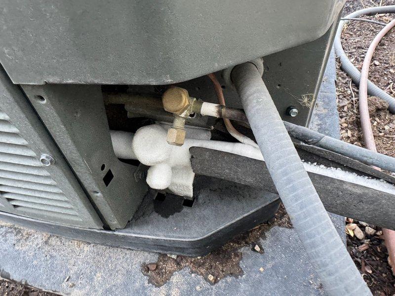 Responded to callback for non-responsive thermostat issue where occupant had to shut off breaker to stop unit operation. Performed diagnostic inspection of AC system and assessed refrigerant lines, condenser unit access compartment, and fan assembly operation. Inspected internal components including brass fittings, copper lines, and insulated refrigerant piping for proper function. Evaluated system for thermostat communication issues and verified unit cycling. Conducted additional assessment regarding potential return air modifications discussed during previous service visit. Unit operational at time of departure with thermostat control restored.