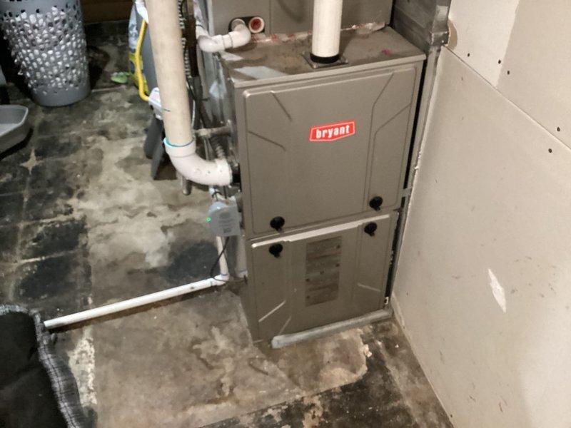Completed comprehensive Cool 10+ preventive maintenance on 7-year-old Bryant furnace system. Performed full system inspection including filter check, blower assembly examination, heat exchanger visual inspection, gas pressure testing, combustion analysis, thermostat calibration verification, and condensate drain line assessment. Cleaned blower components, verified proper airflow, tested all safety controls and limit switches, and confirmed system operation within manufacturer specifications. Noted evidence of previous moisture issues on basement floor near equipment but confirmed current condensate drainage functioning properly with no active leaks. All electrical connections inspected and tightened, burner assembly cleaned, and flame sensor serviced. System cycling properly with no fault codes present and all operational parameters normal upon completion.